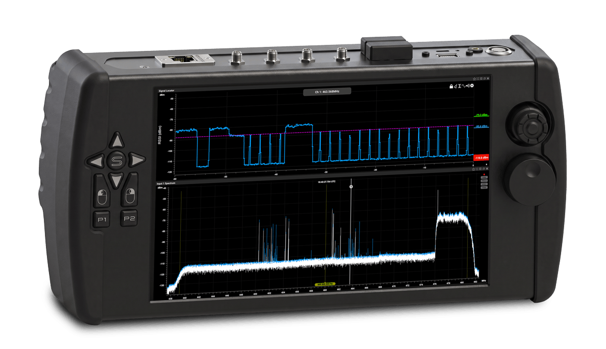 Nomad handheld signal analyzer — rugged tablet body with joystick and keypad controls, screen showing a Signal Locator RSSI trace above a wideband spectrum sweep